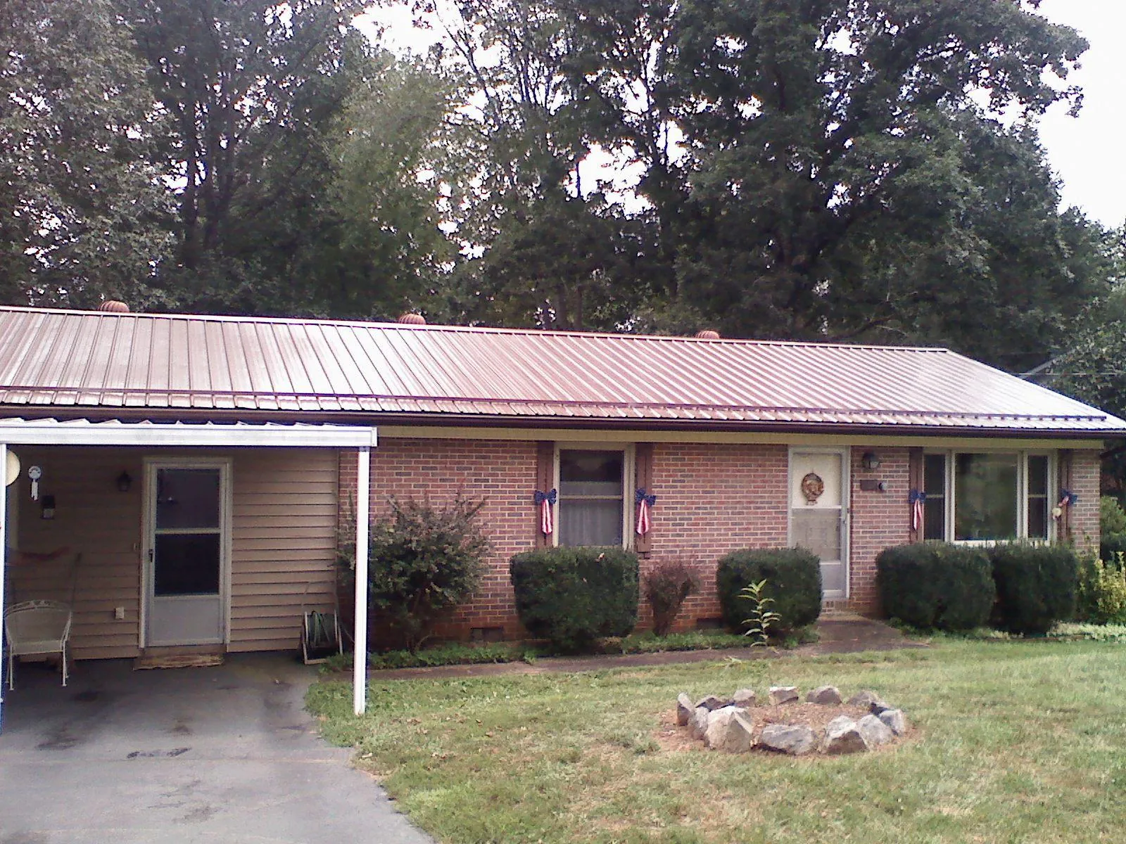 Bronze metal roof and carport on a brick ranch home — Roof Repair work by our crew in Hummelstown