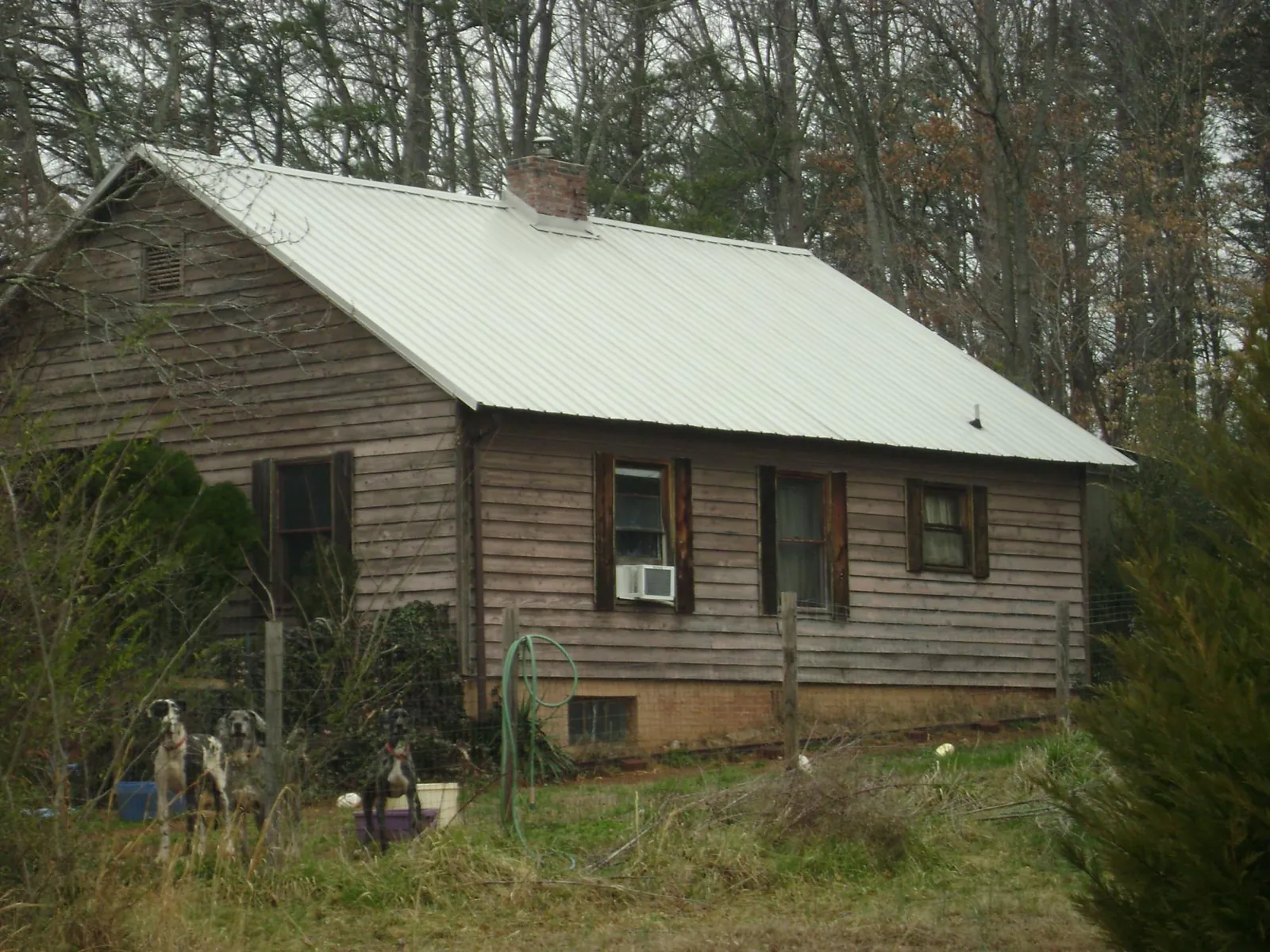 White metal roof on an old wood sided farmhouse, from a Metal Roof Installation job in Hummelstown